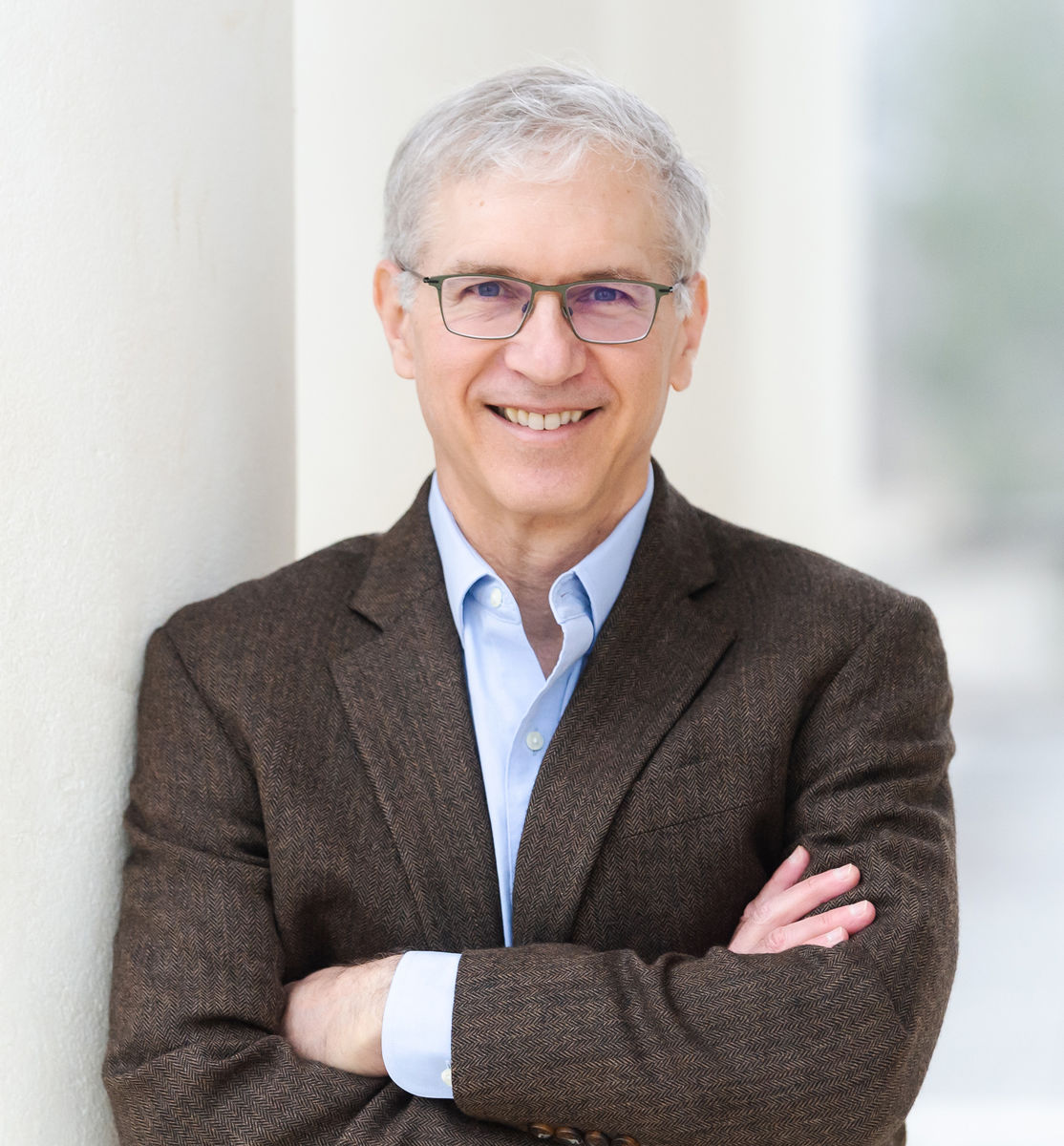 image of Marc Selvestone, wearing glasses, wearing a blue button down shirt and dark grey blazer