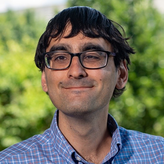 image of Enghin Atalay wearing glasses in a blue button down shirt