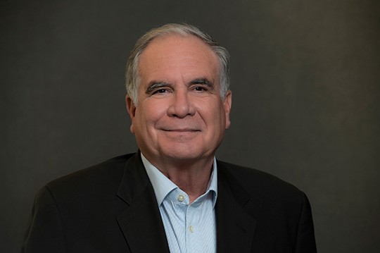 image of Miguel Centeno in a black blazer and blue dress shirt
