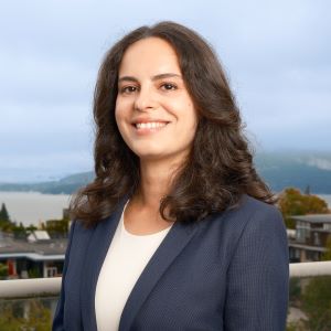 image of Giulia wearing a white top and blue suit smiling at the camera