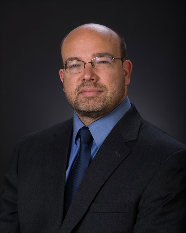photo is a headshot of Dr. Gvosdev sitting in a suit and looking into the camera