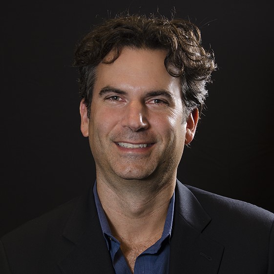 image of Mitchell Orenstein in a black polo short against a black background