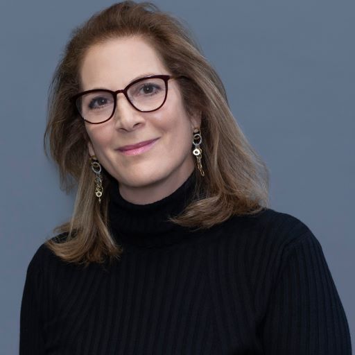 image of Natasha Rogoff, wearing glasses, wearing a black turtleneck