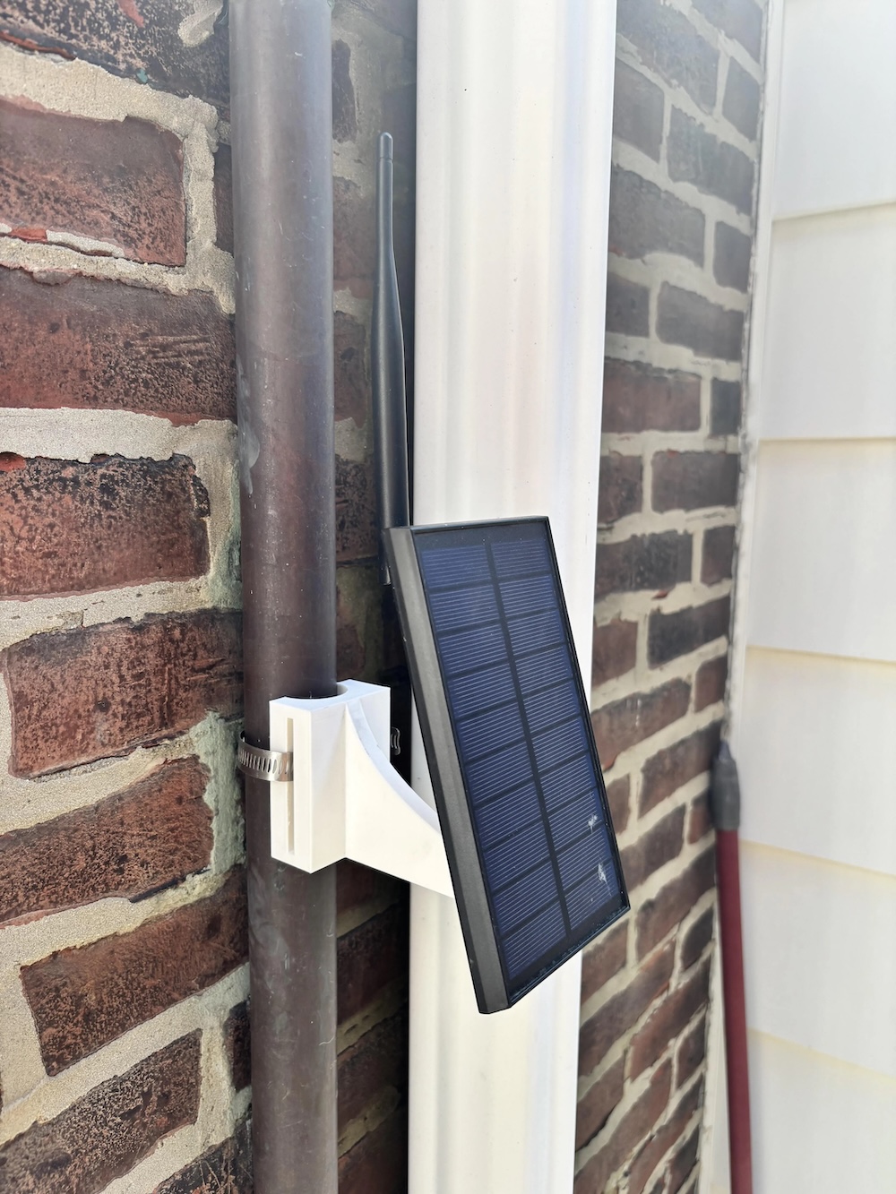 Solar panel mounted on a brick wall.