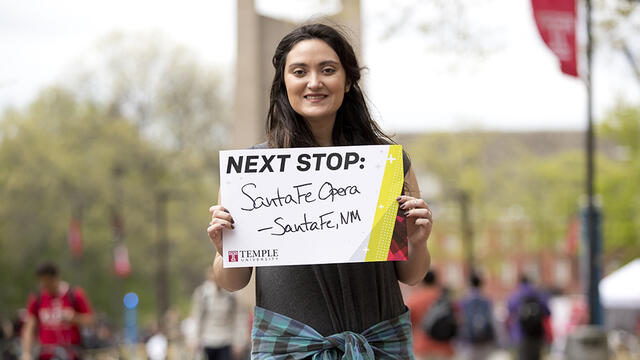 Courtney Banks holding a sign that says