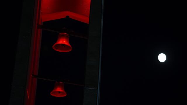The moon shining above the Bell Tower on Main Campus.