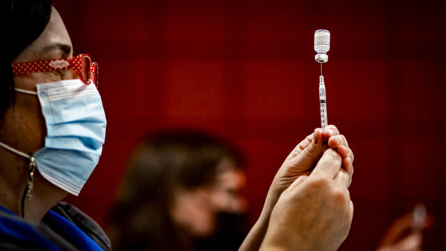 An staff member from Student and Employee Health Services gets ready to administer the COVID-19 vaccine.