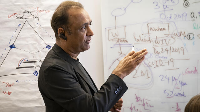 Sudhir Kumar teaching in front of a white board