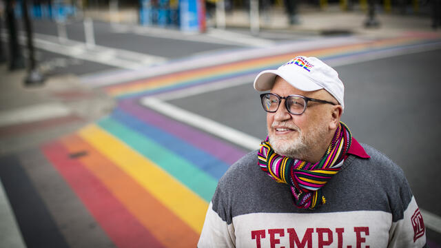 Scott Gratson standing at the rainbow crosswalks on 13th and Locust in Philadelphia