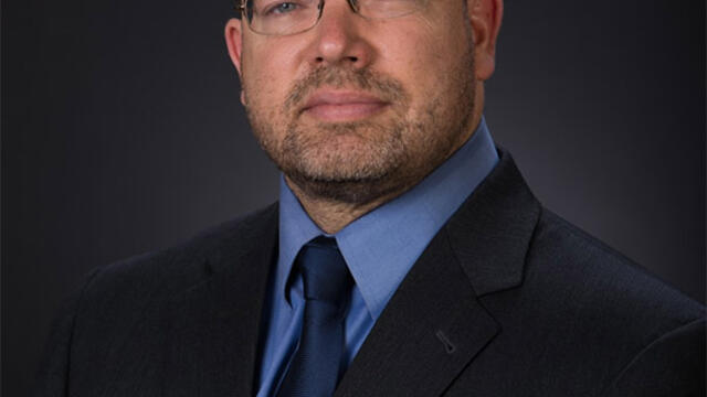 photo is a headshot of Dr. Gvosdev sitting in a suit and looking into the camera