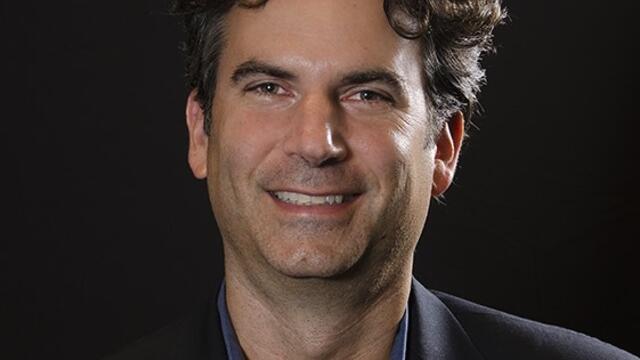 image of Mitchell Orenstein in a black polo short against a black background