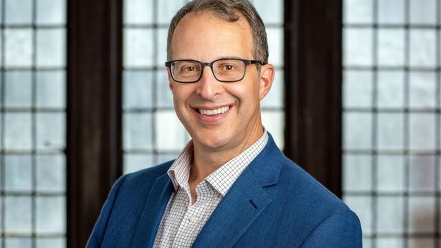 image of David Engerman, wearing glasses, in a white button down shirt and blue blazer