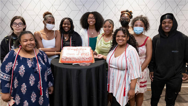 Temple Education Scholars with a cake