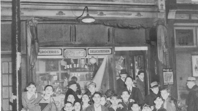 Image of children outside Mr. Joe Grimm s store the day after three men were shot there, two fatally.