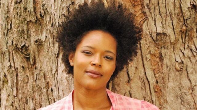Yolanda Wisher posing in front of a tree.