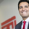Kevin Negandhi smiling with an ESPN logo in the background.