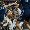 A woman basketball player with a ball in her hands.
