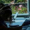 Students studying in Charles Library, with the green roof visible through a window nearby.