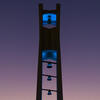 The Bell Tower at night lit up in teal