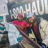 Image of two men wearing Temple branded hats in front of truck